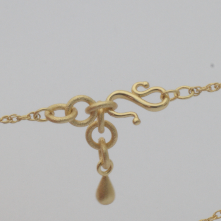 Anchor Clasp by Nudie – studio photo on white background showing the unique self-fastening clasp designed for easy wear with nails or limited dexterity.
