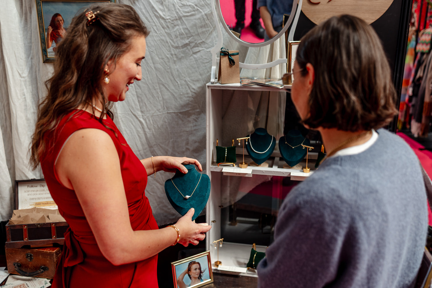 Two women looking at jewelry in a store