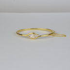 Avalon Bangle by Nudie – studio photo on white background showing the open bangle laid flat, with hammered gold finish and crystal detail at one end.